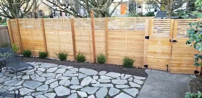 Flagstone patio with a new horizontal slat cedar fence